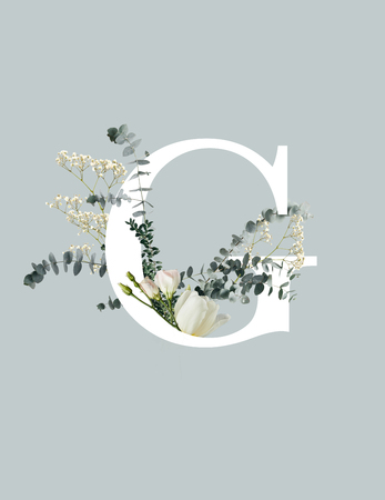 White letter C with wildflowers, buds and green leaves isolated on grey backgroundの写真素材