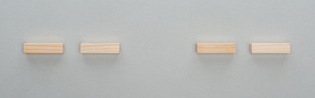 Panoramic shot of wooden bricks isolated on grey backgroundの写真素材