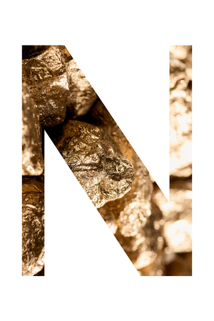 Letter N made of shiny golden stones isolated on whiteの写真素材