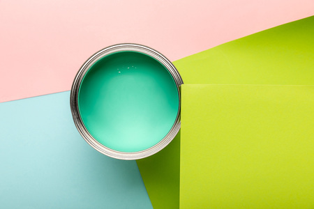 Top view of tin with green paint on colorful surfaceの写真素材