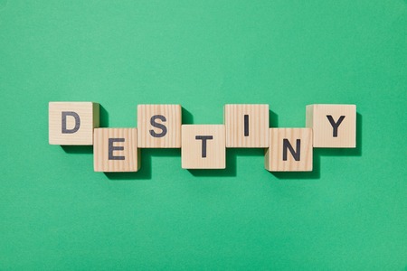 Top view of wooden blocks with letters on green surfaceの写真素材