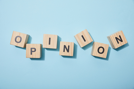 Top view of wooden cubes with letters on blue surfaceの写真素材