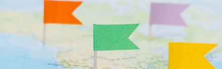 Panoramic shot of colorful flags pinned on world mapの写真素材