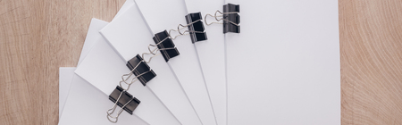Panoramic shot of stacks of blank paper with metal paper clips and copy spaceの写真素材