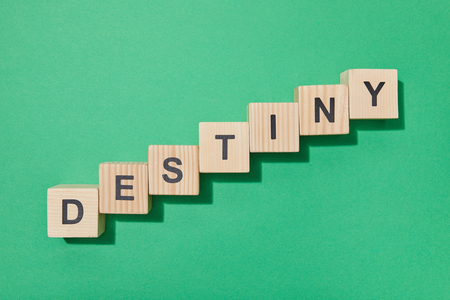 Top view of wooden blocks with letters on green surfaceの写真素材