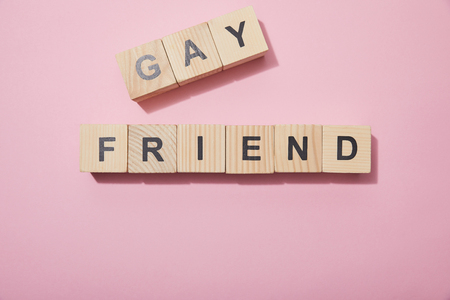 Top view of wooden cubes with letters on pink surfaceの写真素材