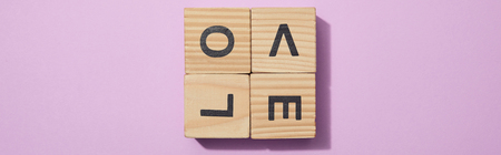 Panoramic shot of wooden blocks with letters on purple surfaceの写真素材