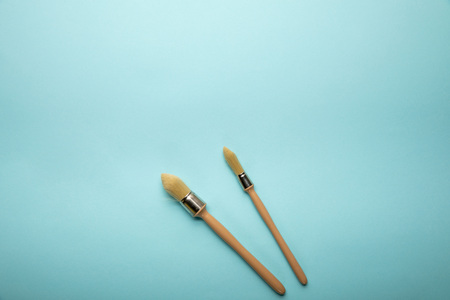 Top view of two brushes on blue surfaceの写真素材