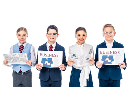 smiling schoolchildren pretending to be businesspeople with newspapers looking at camera Isolated On Whiteの写真素材