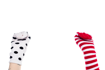 partial view of person with colorful sock puppets on hands Isolated On White with copy spaceの写真素材