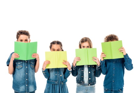 Four kids in denim clothes holding books isolated on white background