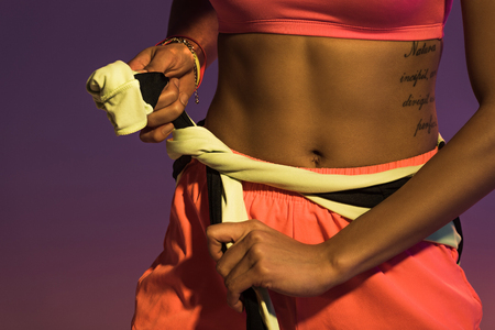 partial view of tattooed african american girl on purple backgroundの写真素材