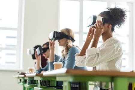 selective focus of multiethnic students using vr headsets in universityの写真素材