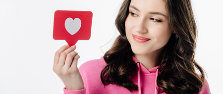 panoramic shot of pretty girl holding red paper cut card with heart symbol isolated on white