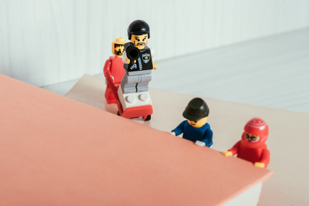 KYIV, UKRAINE - MARCH 15, 2019: plastic lego minifigures carrying book near policeman figureのeditorial素材