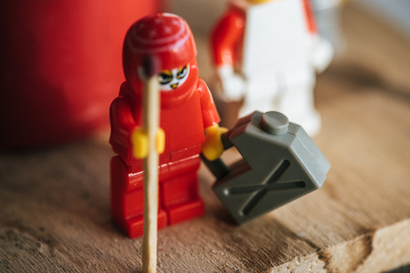 KYIV, UKRAINE - MARCH 15, 2019: close up view of plastic lego figurine with can of gasoline and matchのeditorial素材