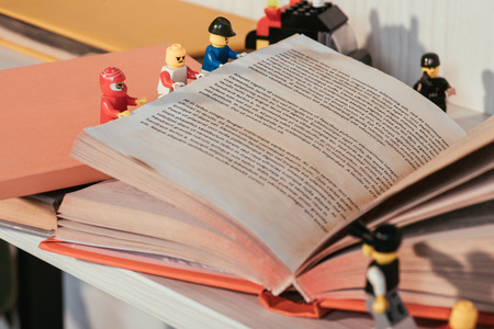 KYIV, UKRAINE - MARCH 15, 2019: selective focus of colorful plastic lego minifigures turning book pageのeditorial素材