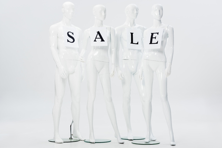 papers with sale lettering on white mannequins isolated on greyの写真素材