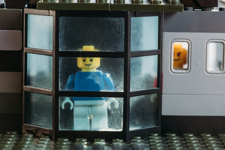 KYIV, UKRAINE - MARCH 15, 2019: yellow lego figurines looking through window in block houseのeditorial素材