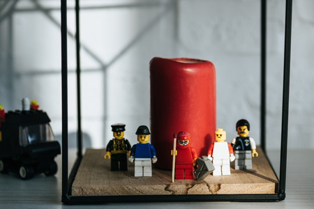 KYIV, UKRAINE - MARCH 15, 2019: red figurine with can of gasoline and match standing with lego characters near candleのeditorial素材