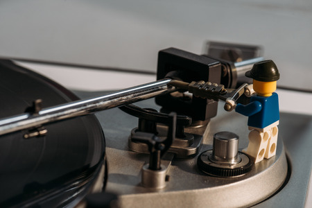 KYIV, UKRAINE - MARCH 15, 2019: close up view of plastic lego figurine fixing vinyl record playerのeditorial素材