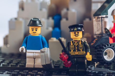 KYIV, UKRAINE - MARCH 15, 2019: Selective Focus of lego policeman figurine and figurine with toy gasoline canのeditorial素材