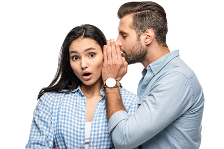 man telling secret to shocked young woman Isolated On Whiteの写真素材