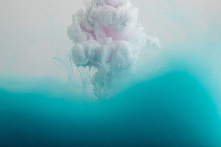 Close up view of white and turquoise smoky paint isolated on greyの写真素材