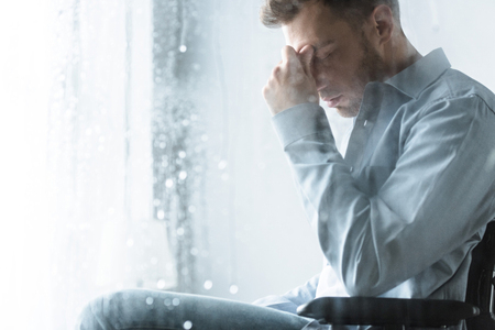 selective focus of sad disabled man on wheelchairの写真素材