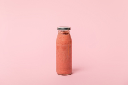 sweet, tasty and fresh smoothie on pink with copy spaceの写真素材