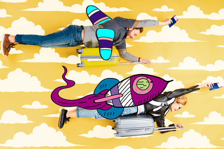 Happy couple flying as rockets in sky on suitcases with passports and air tickets on yellow background with clouds illustrationの写真素材