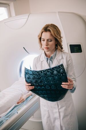 Attentive radiologist examining tomography diagnosis during patients diagnostics