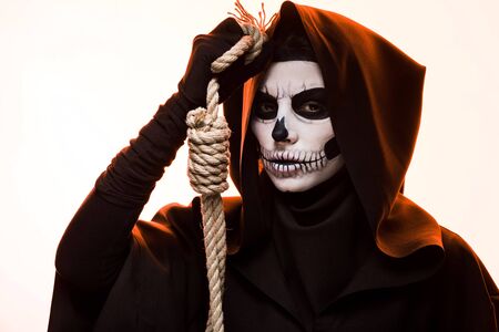 Woman in death costume holding hanging noose isolated on white backgroundの写真素材