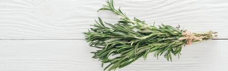 top view of fresh green rosemary on white wooden table, panoramic shotの写真素材
