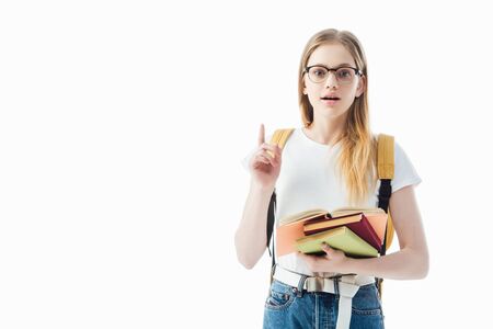 excited schoolgirl with books and backpack showing idea gesture isolated on whiteの写真素材
