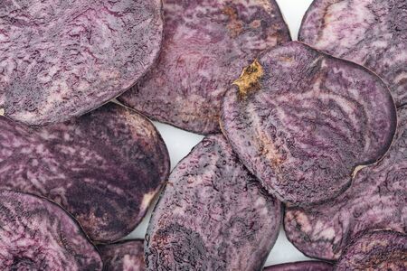 top view of cut fresh purple radish slices in pileの写真素材