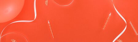 Panoramic shot of birthday party decoration on red background