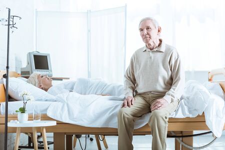 sad senior man and senior woman in coma in hospitalの写真素材
