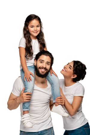happy latin father carrying on shoulders cute daughter near happy wife isolated on whiteの写真素材