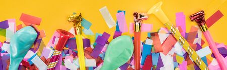 Panoramic shot of party decoration on yellow festive backgroundの写真素材