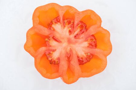 top view of red ripe tomato half isolated on whiteの写真素材