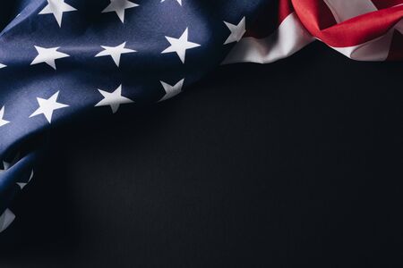 folded american national flag isolated on black, memorial day concept