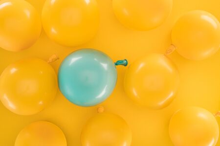 Yellow balloons and blue one on yellow background