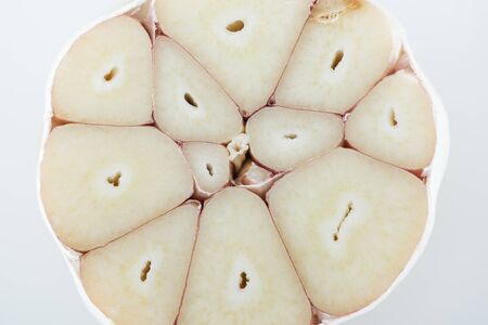close up view of spicy white cut garlic cloves isolated on greyの写真素材