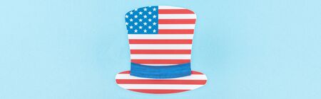 top view of paper cut decorative hat made of american flag on blue background, panoramic shot