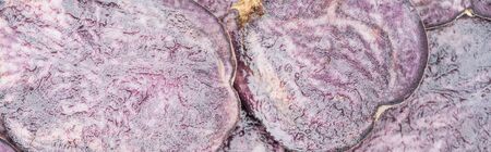 panoramic shot of cut purple radish slices in pileの写真素材
