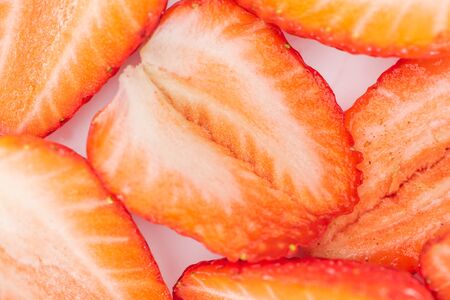 close up view of fresh cut ripe red strawberries in pile