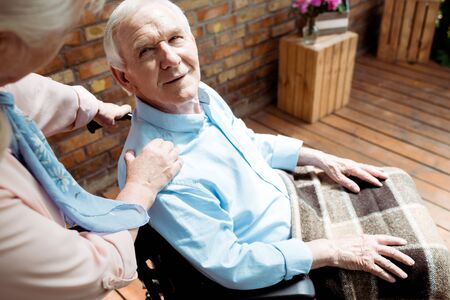 Selective focus of senior disabled man looking at wife