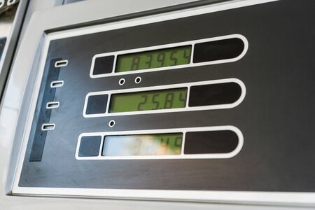 Low angle view of price display on gasoline and benzine at petrol stationの写真素材