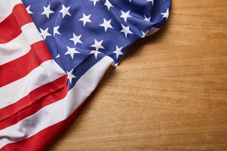 Top view of American flag on light wooden surfaceの写真素材